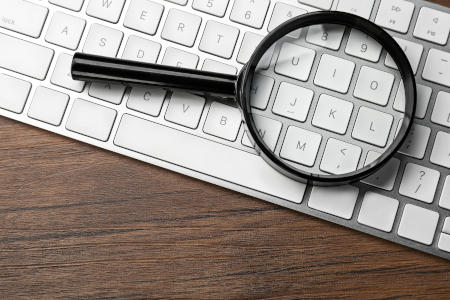 A magnifying glass over a keyboard