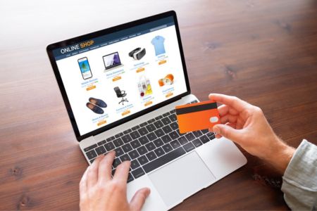 Person on laptop with credit card on e-commerce site