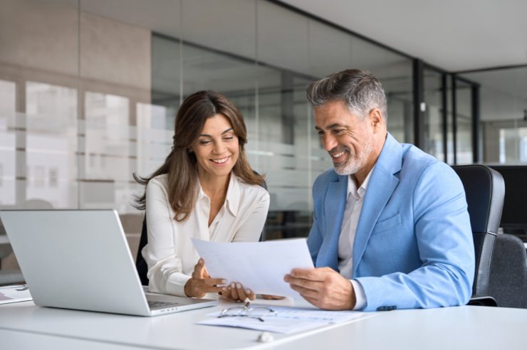 Two attorneys sitting at a desk reviewing a lawyer advertising plan.